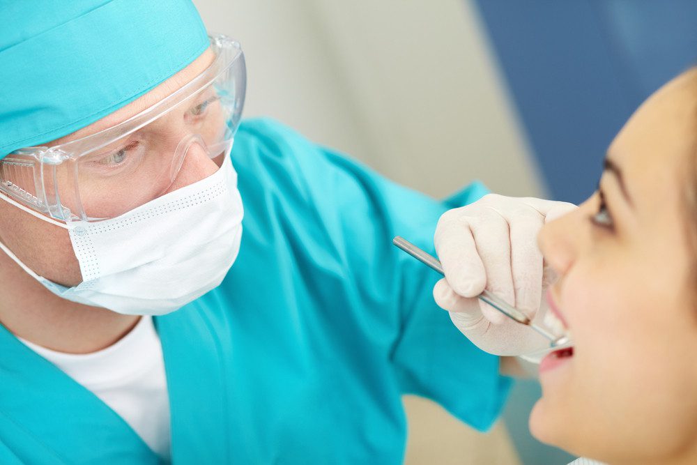 orthodontist examining patient